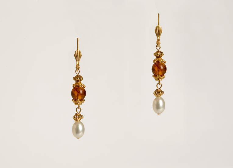 This specific piece of Russian jewelry features Baltic amber, freshwater pearls, and Bukhara link details.